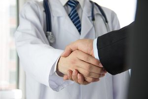 doctor and businessman shaking hands