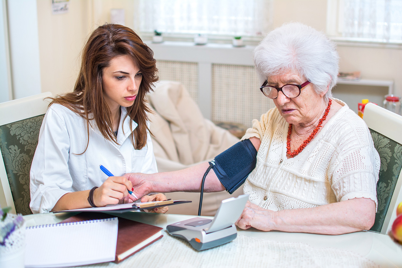 Nurse Practioner checking patient's blood pressure