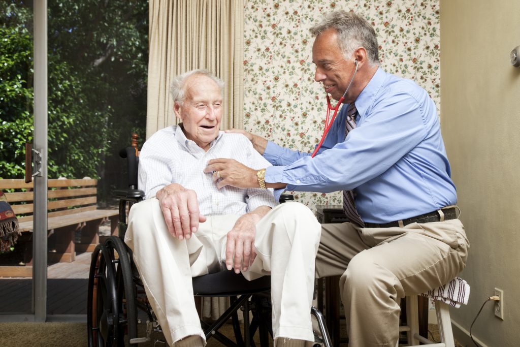 Doctor making a house call on an elderly man